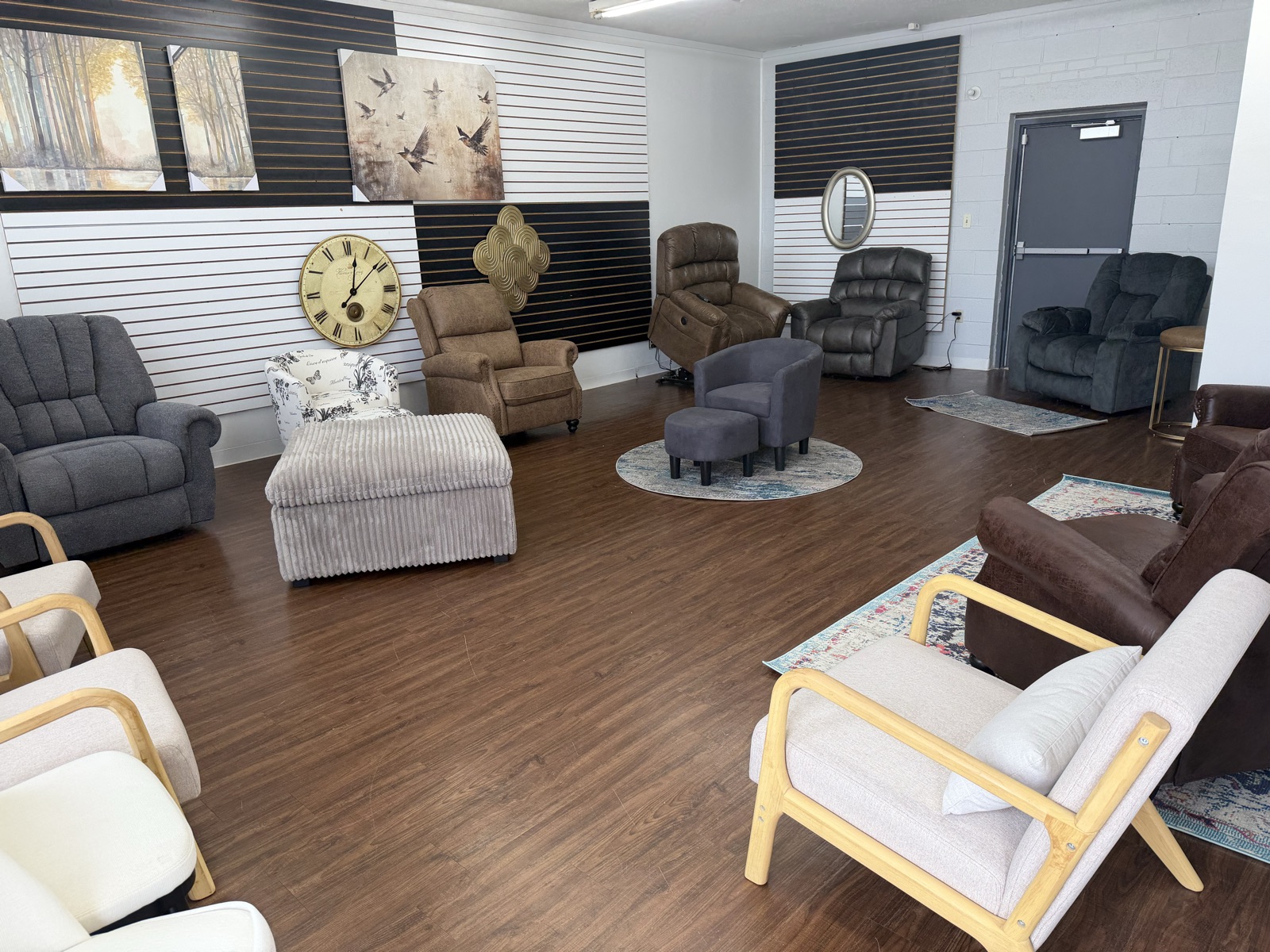 A wide view of the Arts & Accents showroom floor — recliners, accent chairs, rugs, and wall art arranged across the space.