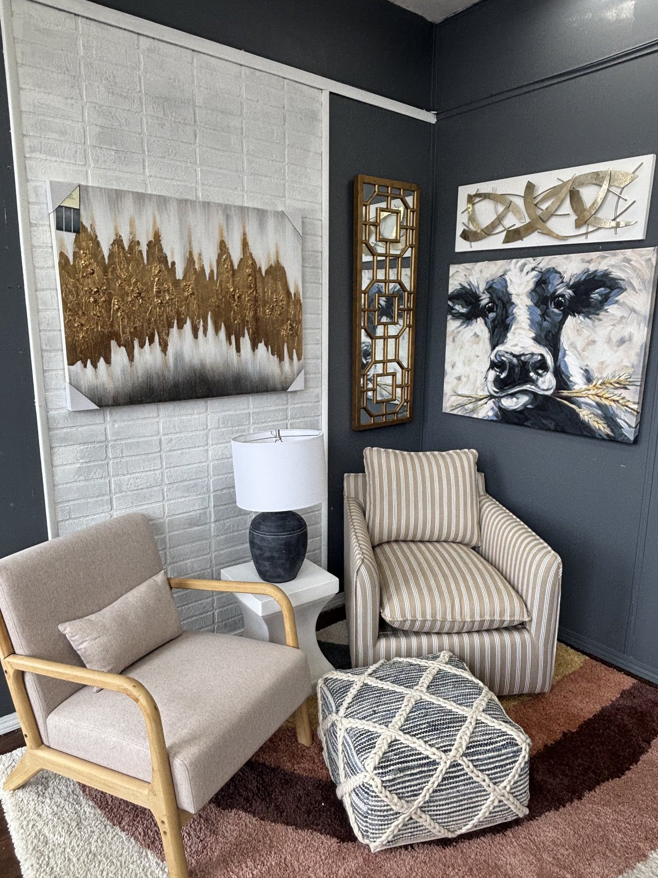 Inside Arts & Accents — accent chairs, original paintings, a striped armchair, and a patterned rug on the showroom floor at 933 N West St, Wichita.